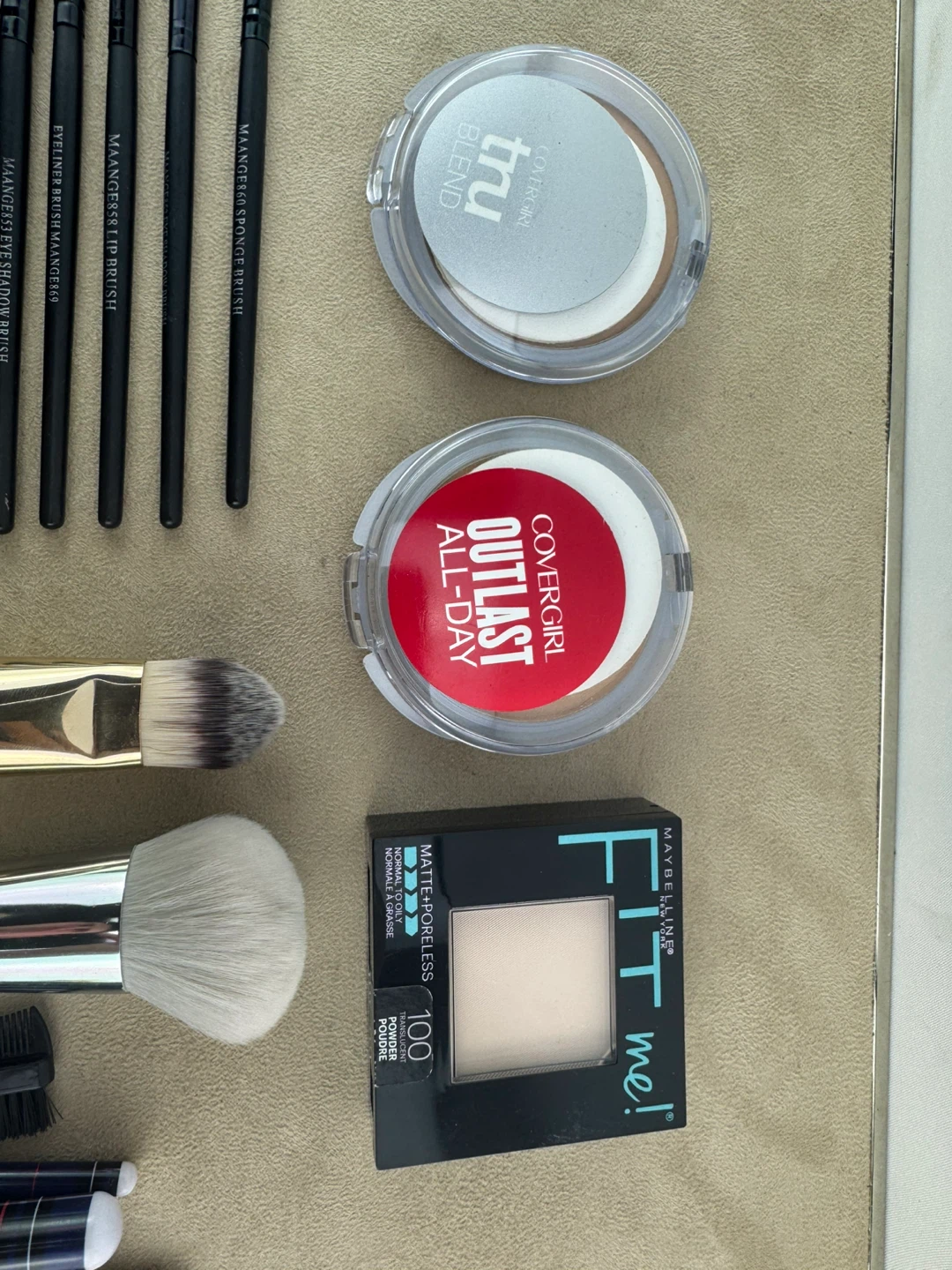 Assorted Makeup Brushes and Cosmetics