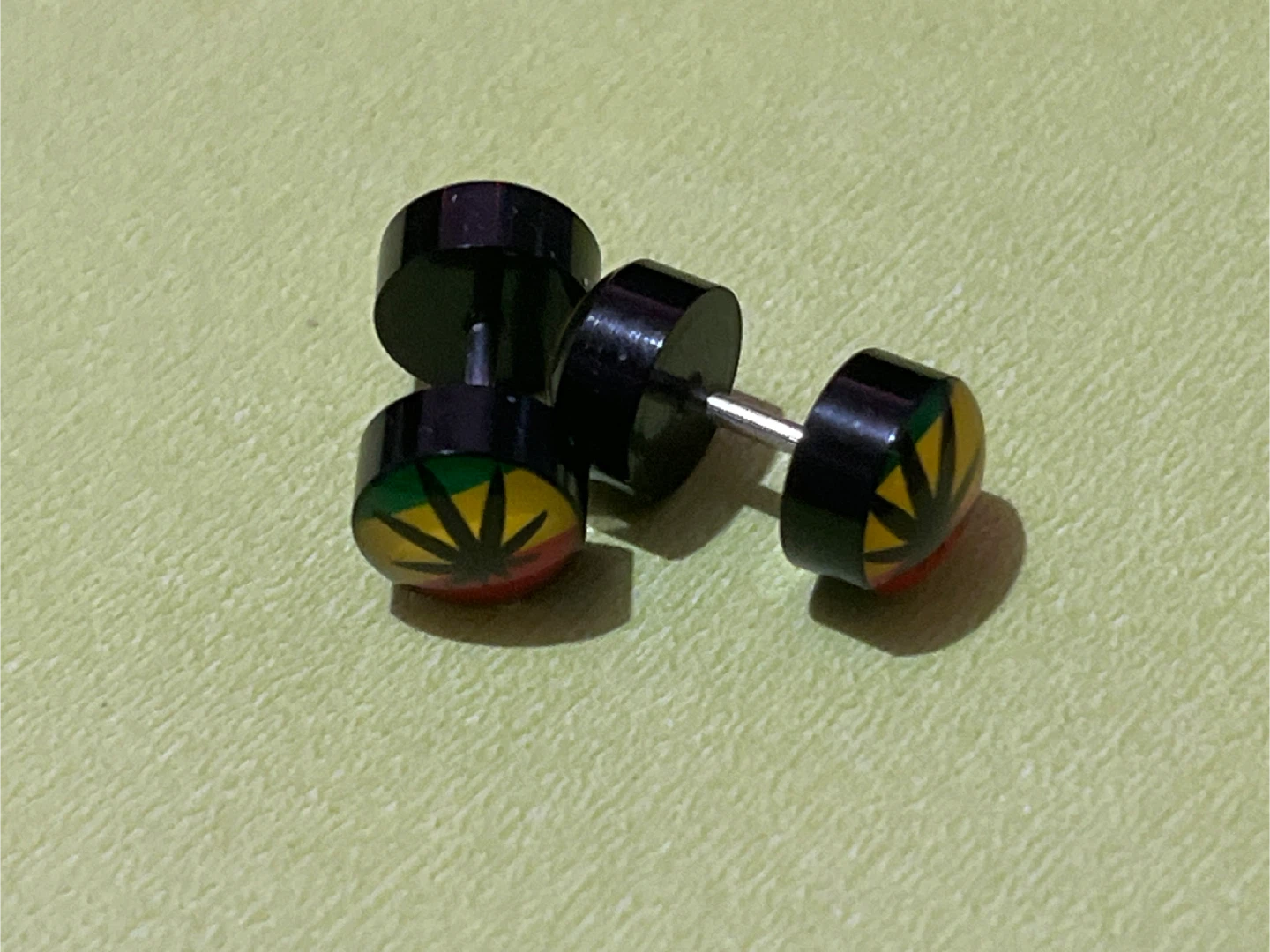 Pair of Black Dumbbell Earrings with Rasta Leaf Design