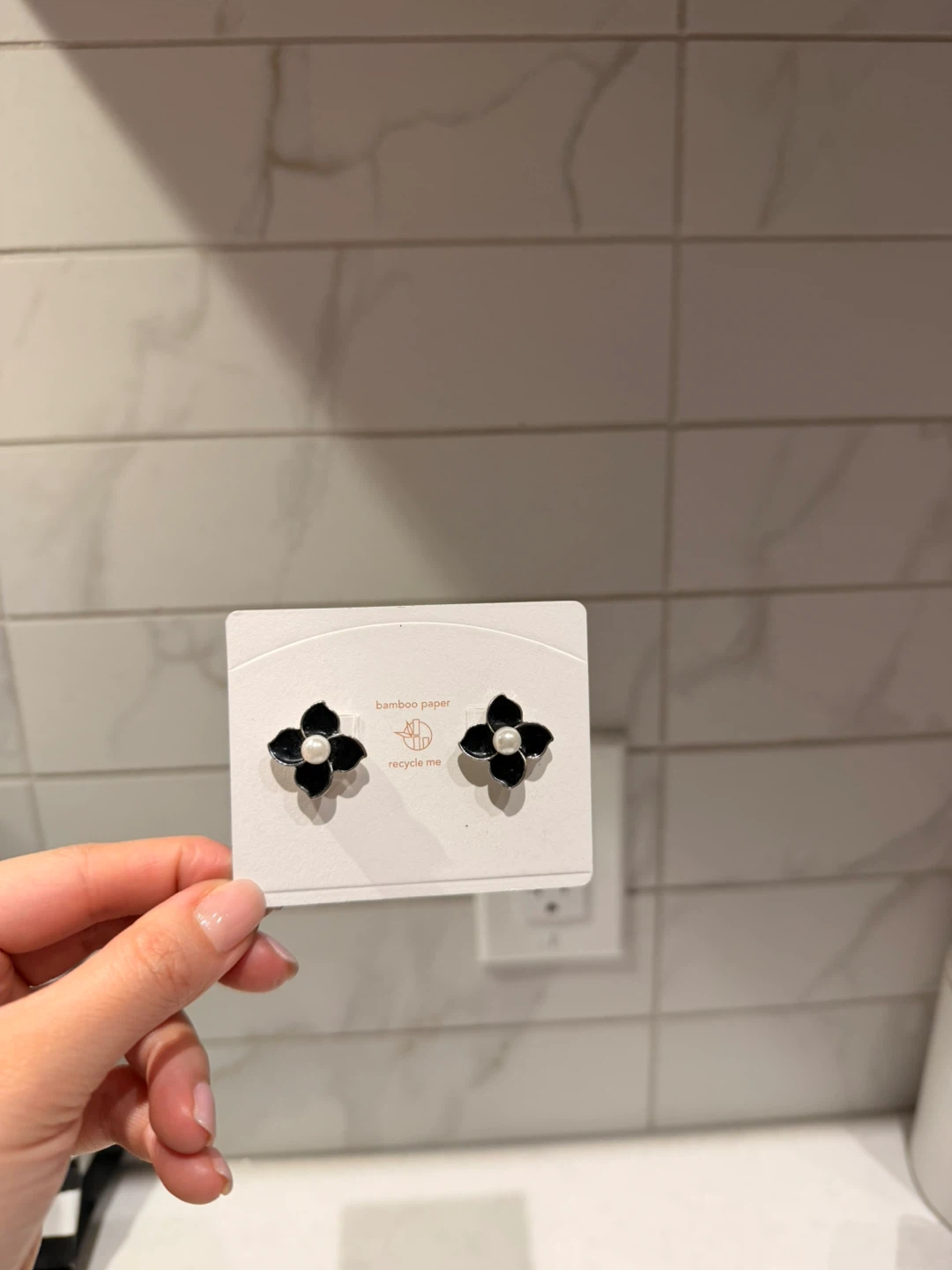 Black floral stud earrings with pearl