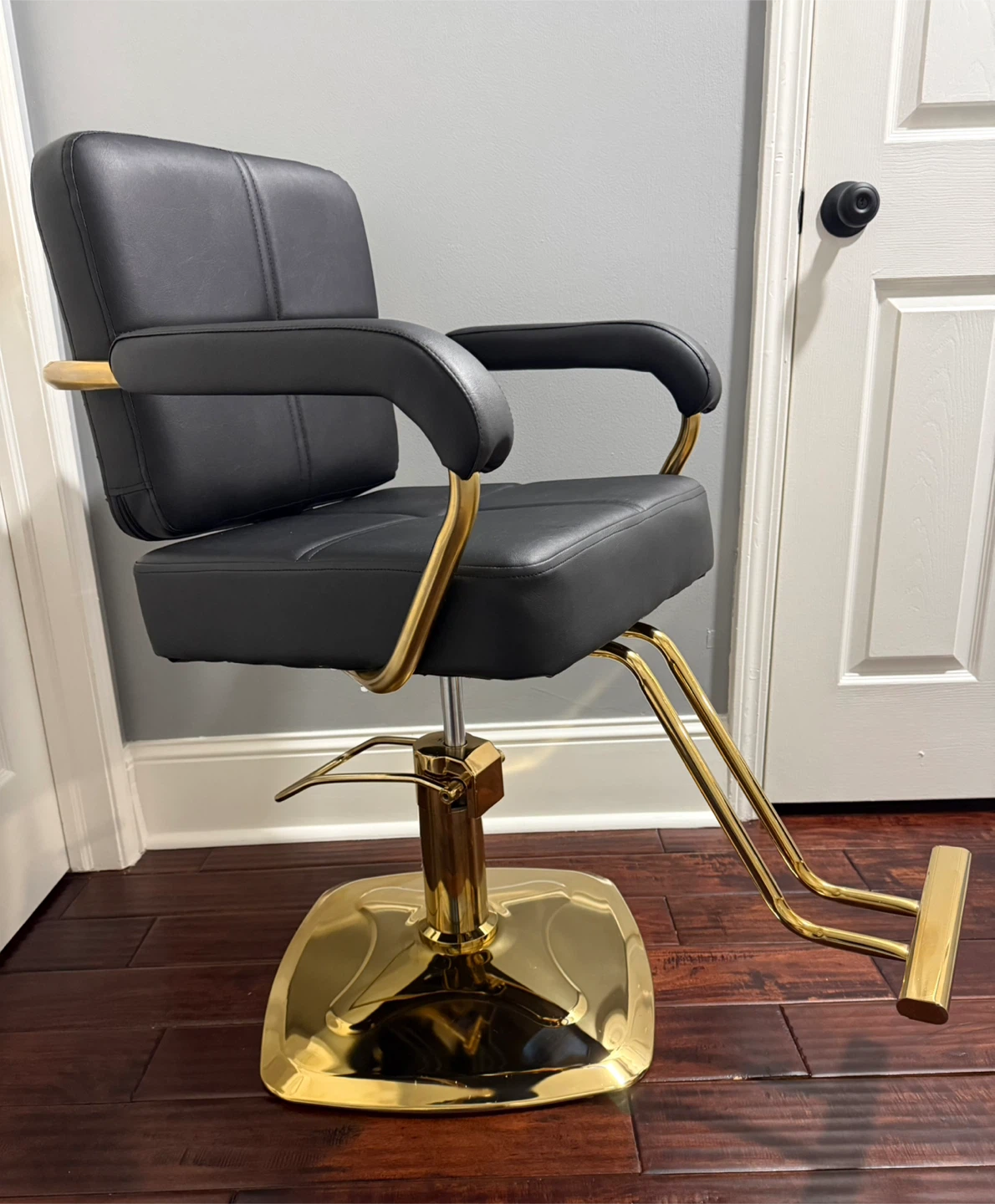 Black Hydraulic Styling Chair with Gold Accents