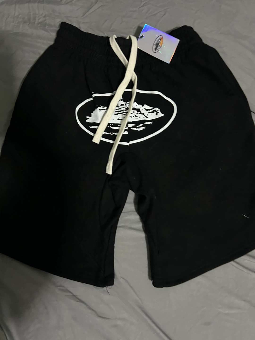 Black shorts with graphic print and drawstring