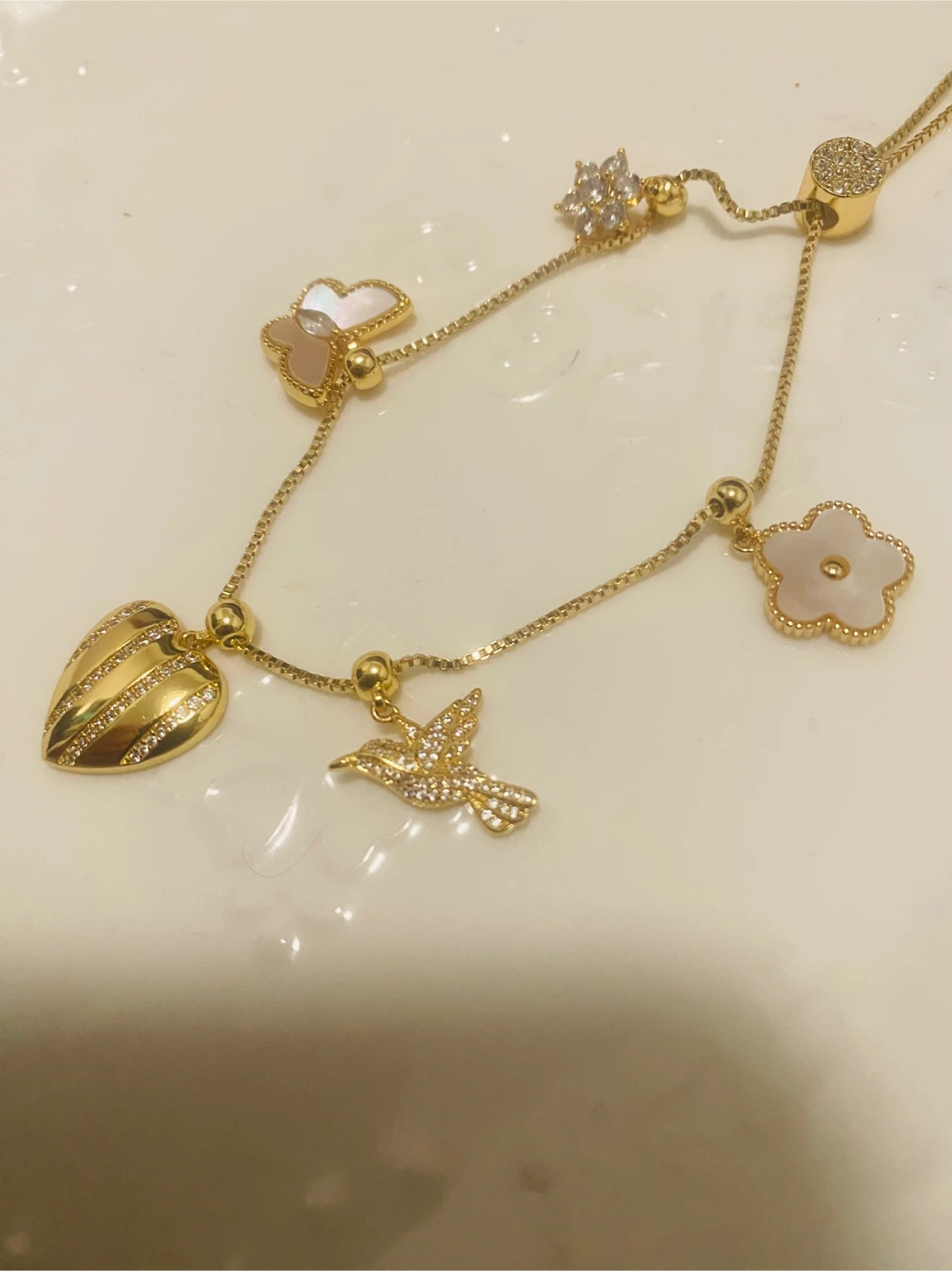 New / unused Gold color Necklace with Charms - photo 3