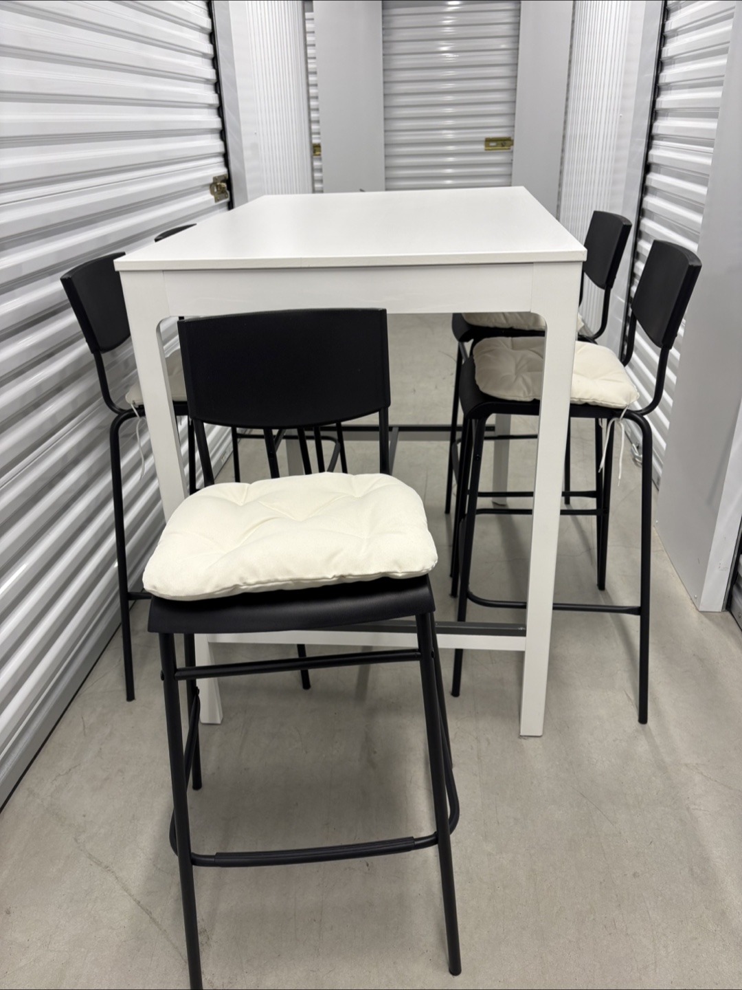Can deliver—White bar table and 5 black bar chairs.