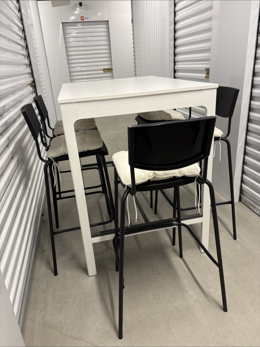 Can deliver—White bar table and 5 black bar chairs. - photo 4