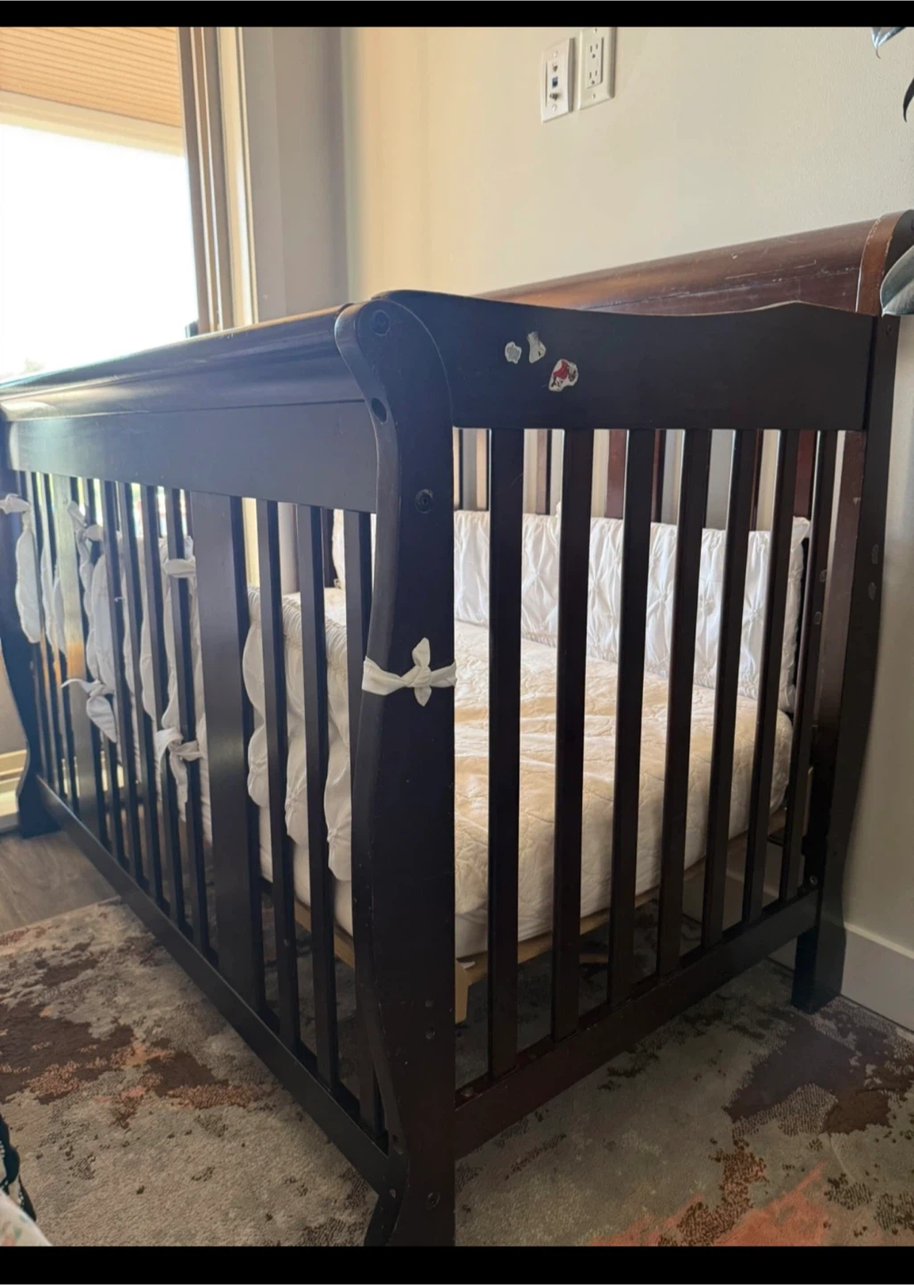 Dark Wood Sleigh Style Crib with Bedding