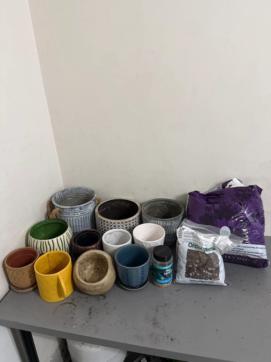 Various Plant Pots, soil, and fertilizer.
