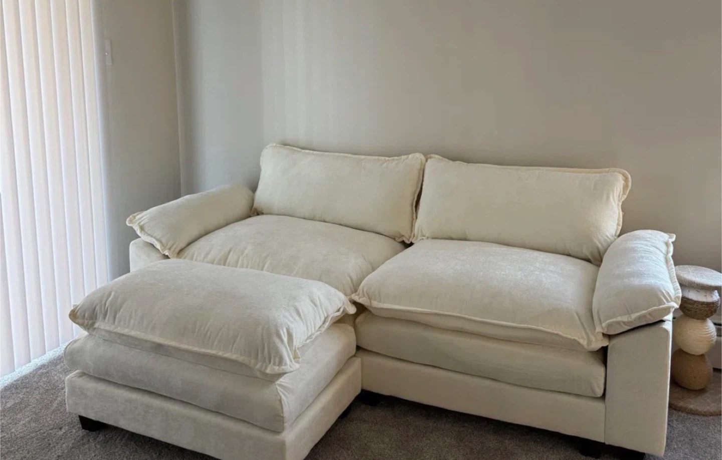 Cream coloured sectional sofa with ottoman