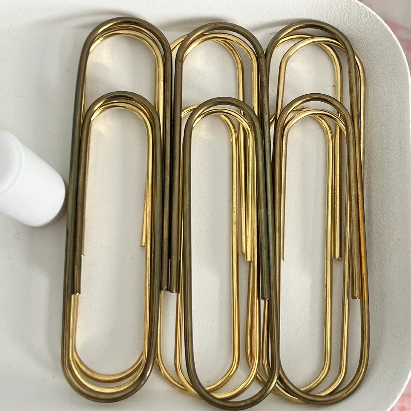 9 gold/brass giant paper clips
