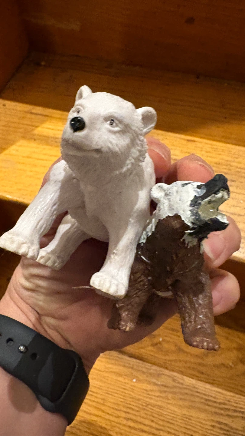 Two toy polar bear figures