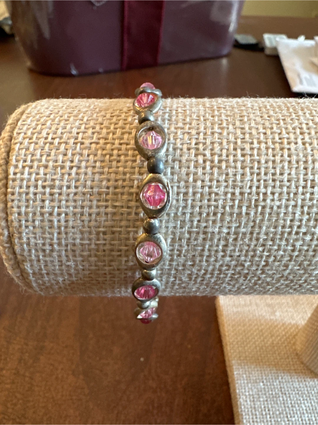 Silver tone bracelet with pink stones