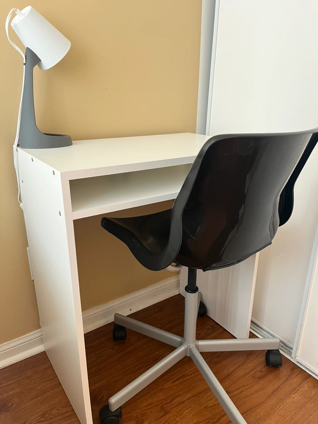 IKEA White Desk with Black Swivel Chair and Lamp