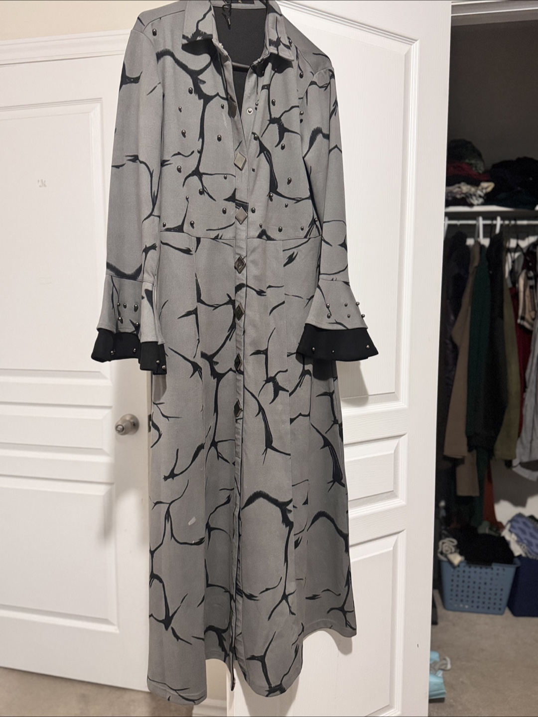 Grey long coat with black pattern and studs
