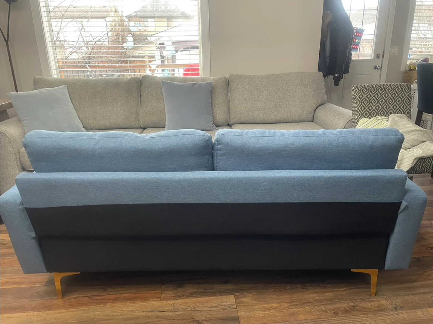 Blue loveseat and a light beige loveseat