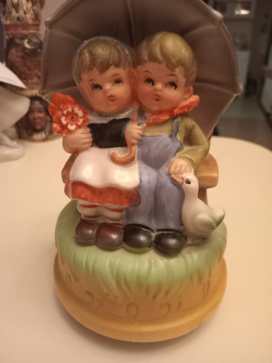 Vintage Figurine of Children Under Umbrella