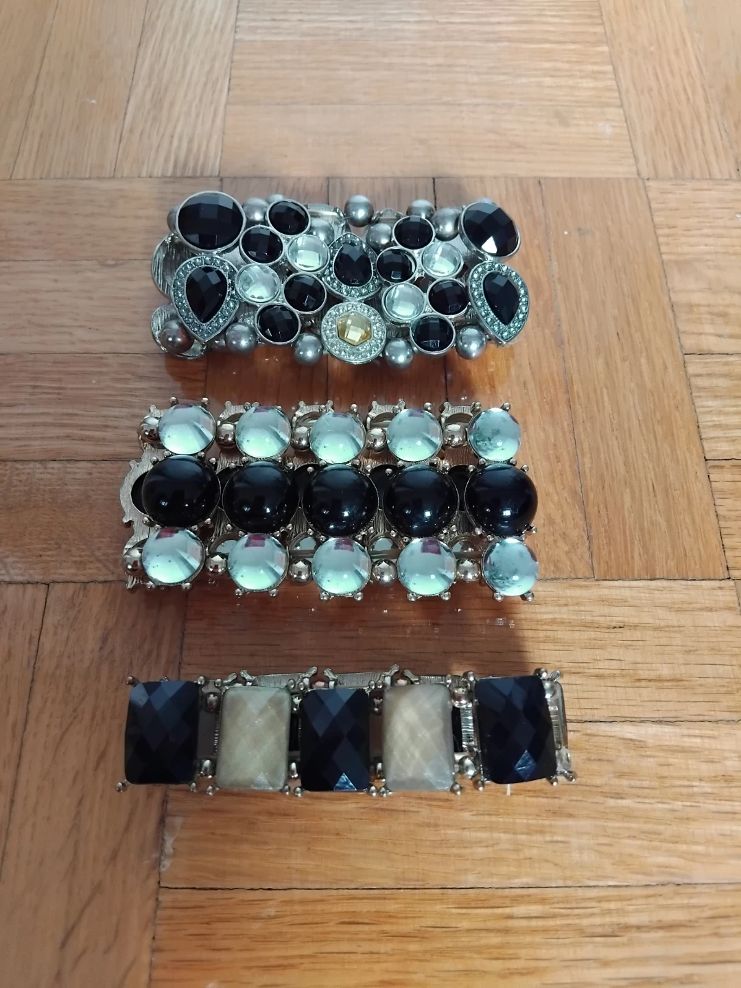 Silver tone elastic bracelets with black and clear gems
