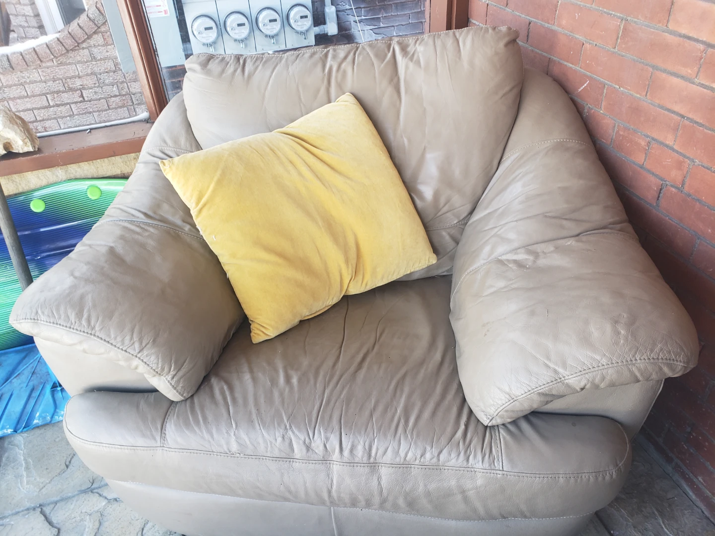 Taupe Leather Armchair with Yellow Pillow