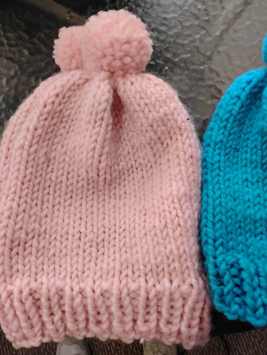 Hand-knitted winter hats with pom-poms