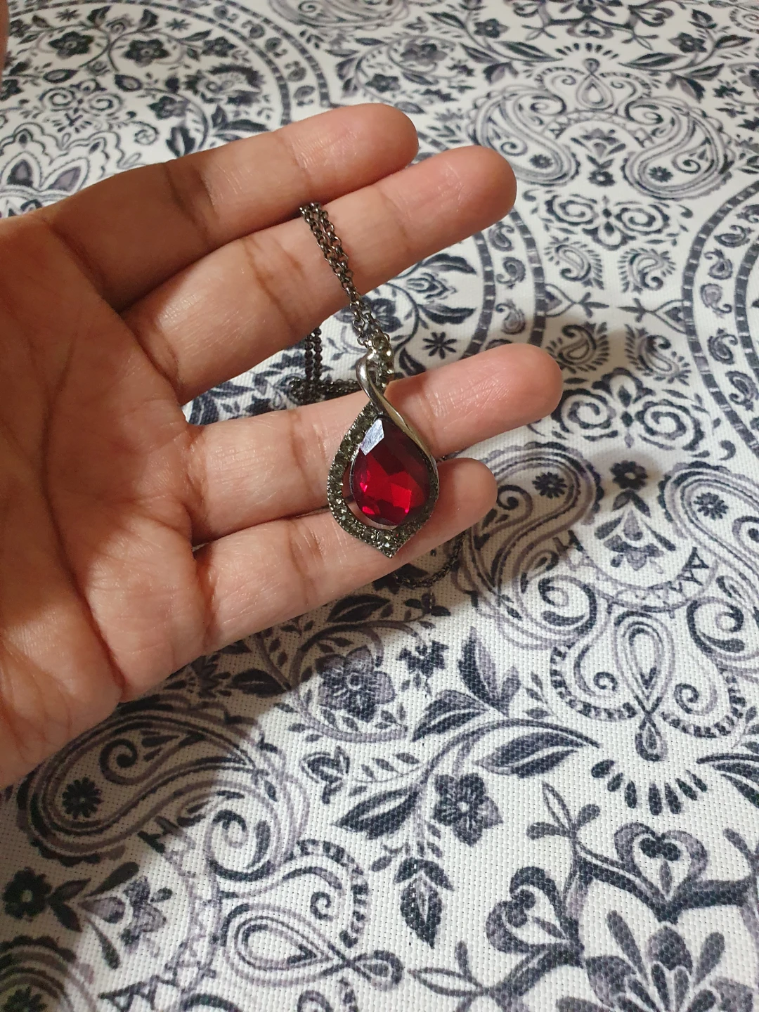 Red teardrop pendant necklace with grey chain