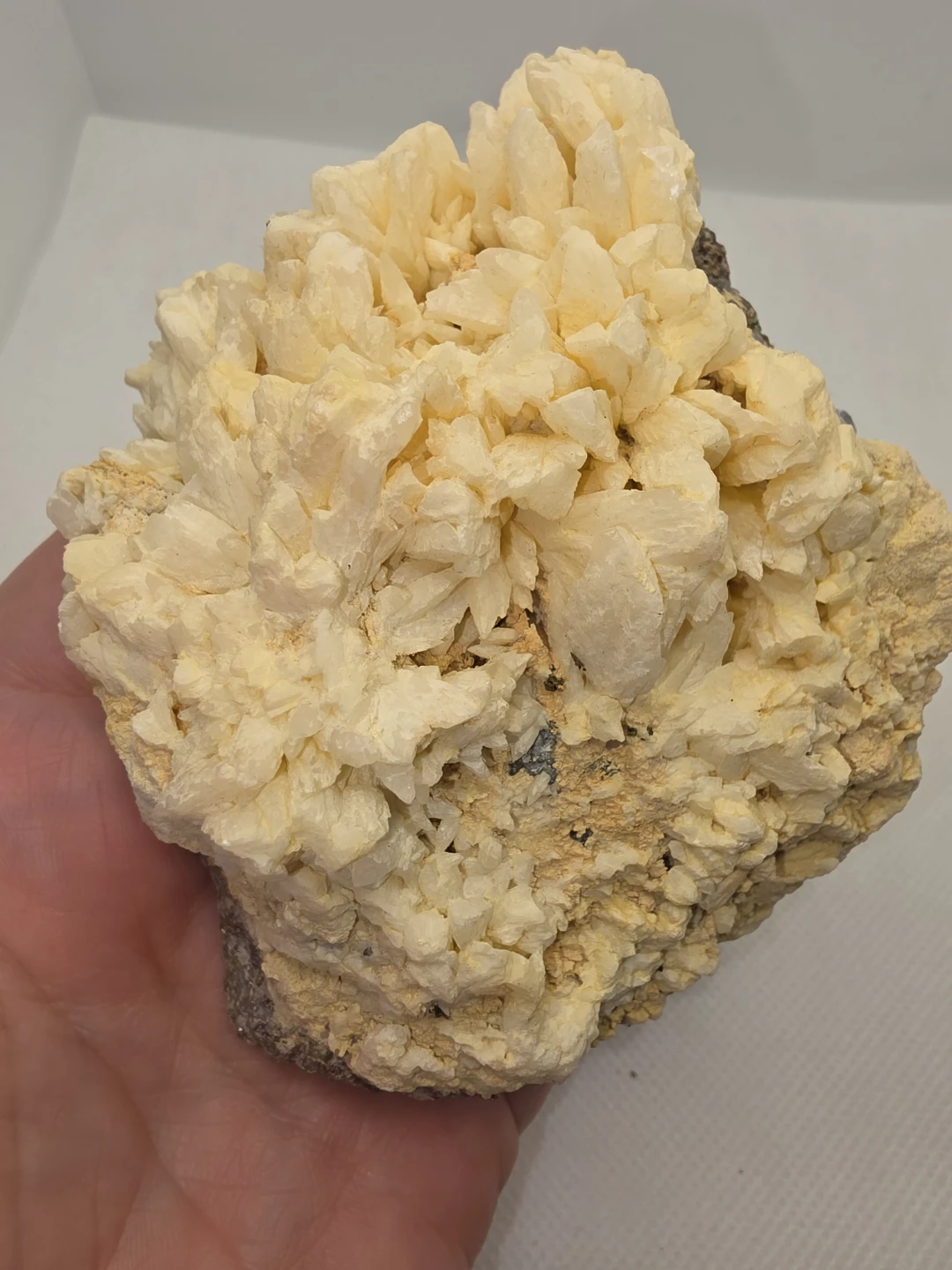 CALCITE CLUSTER IN A MATRIX WITH PYRITE AND SODALITE INCLUSIONS.