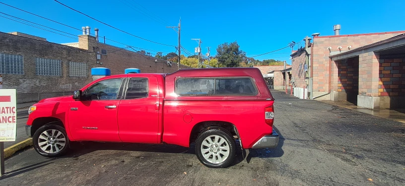Red Toyota Tundra Truck with Camper Shell