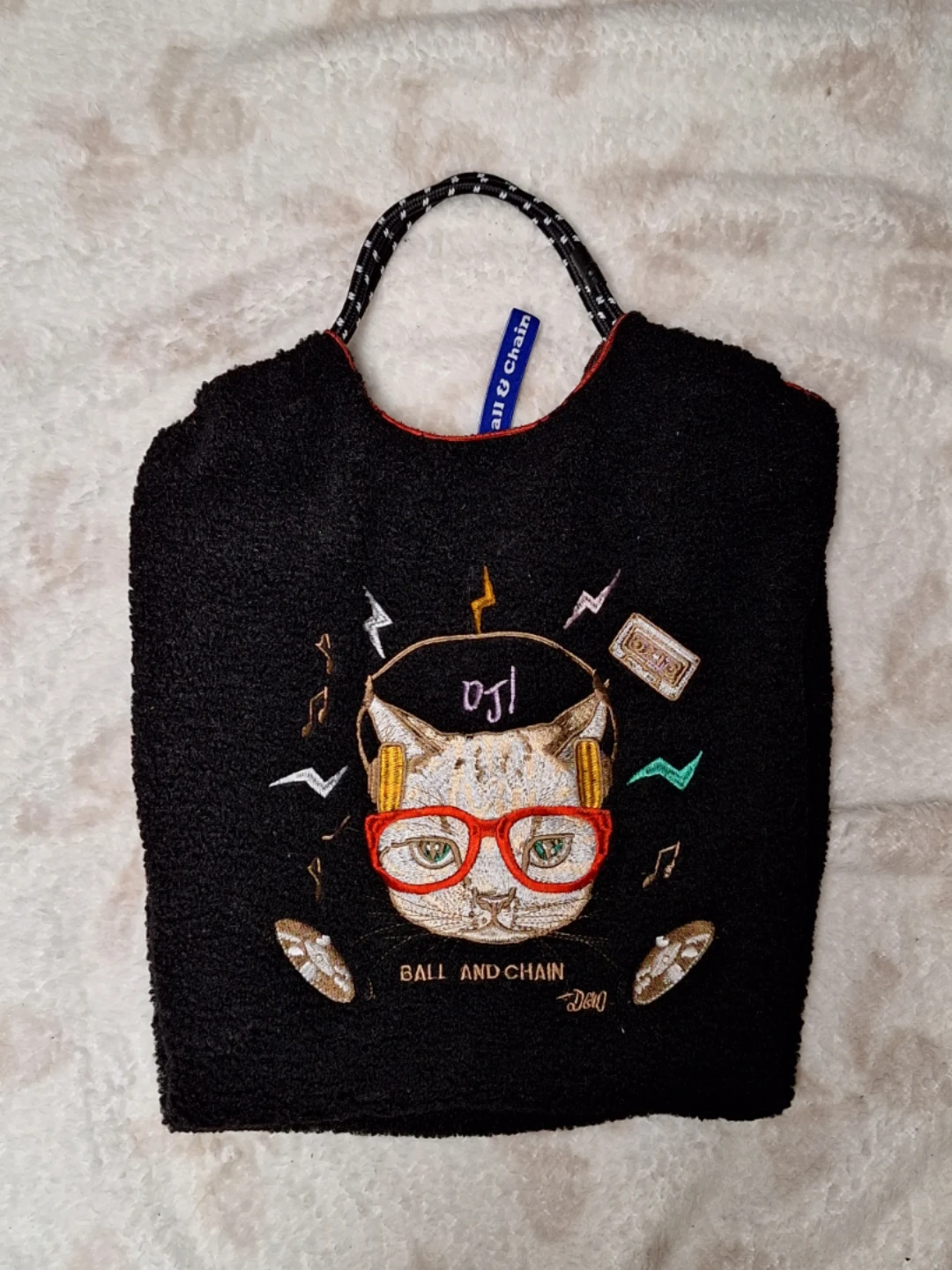 Black tote bag with cat graphic