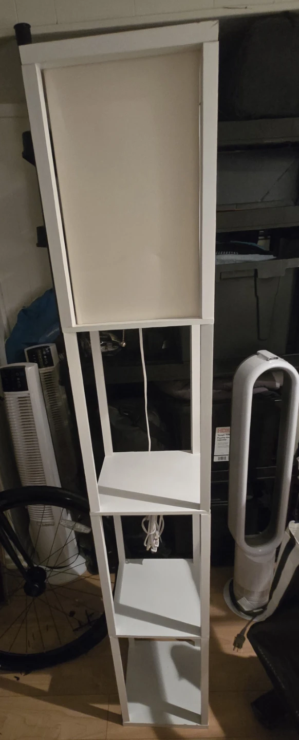 White standing shelf unit with lamp