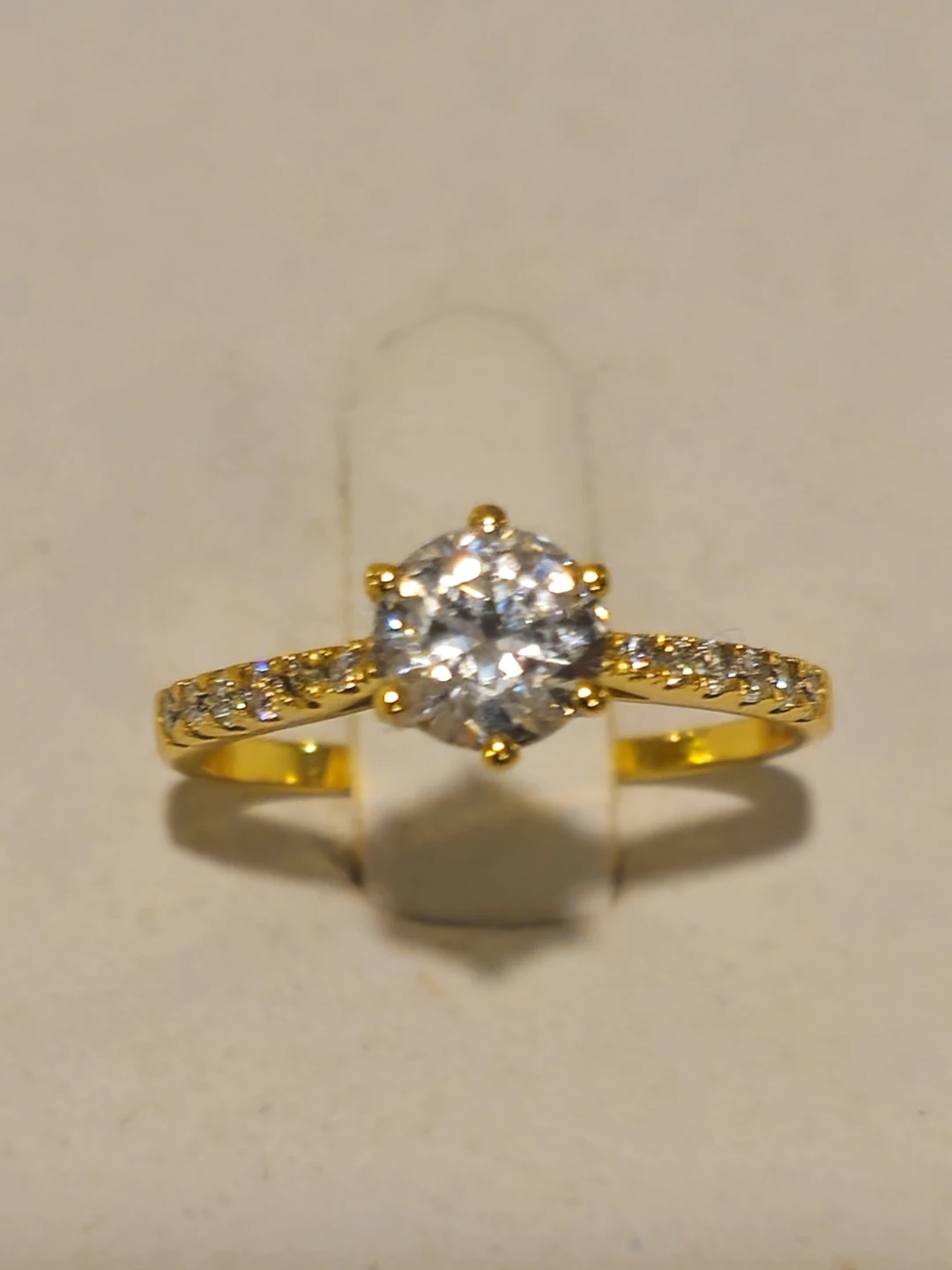 Gold-tone ring with clear stones