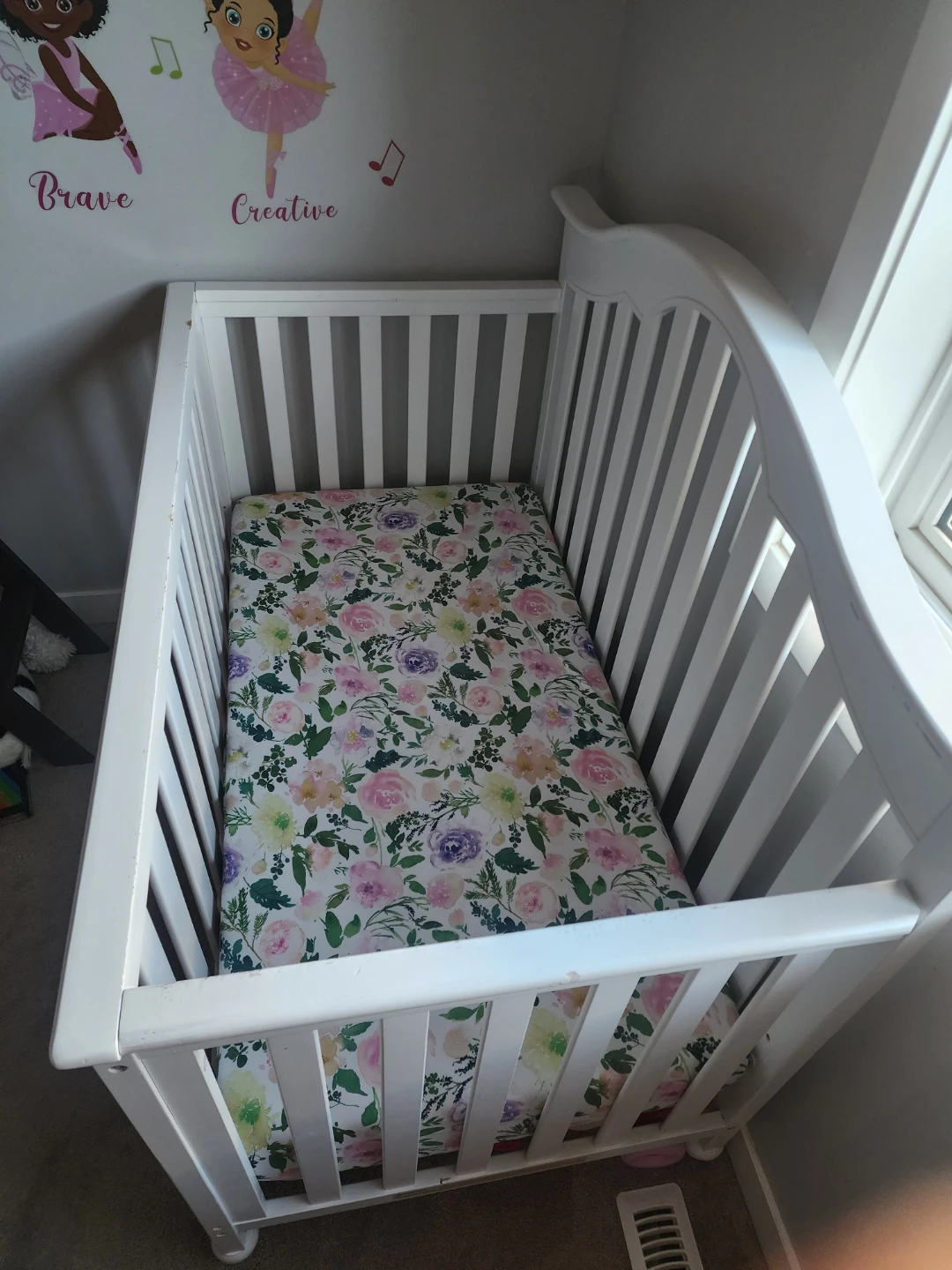 White Baby Crib with Floral Mattress