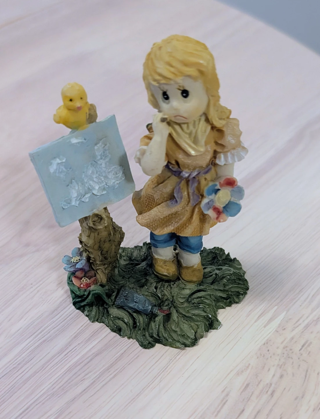 Girl with Chick Figurine