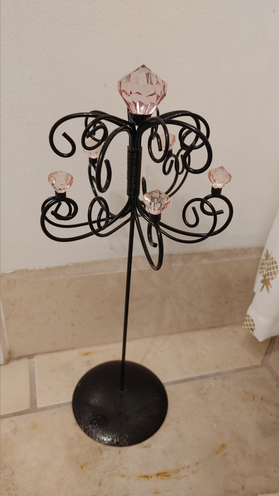 Black metal jewelry stand with pink crystals