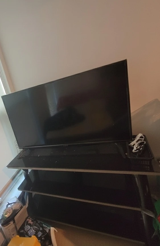Black Flat Screen Smart TV with wooden Stand - 70$
