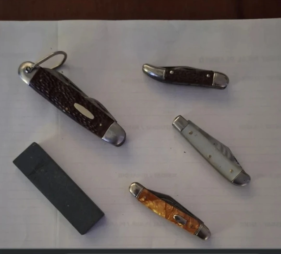 Assorted Pocket Knives and Sharpening Stone
