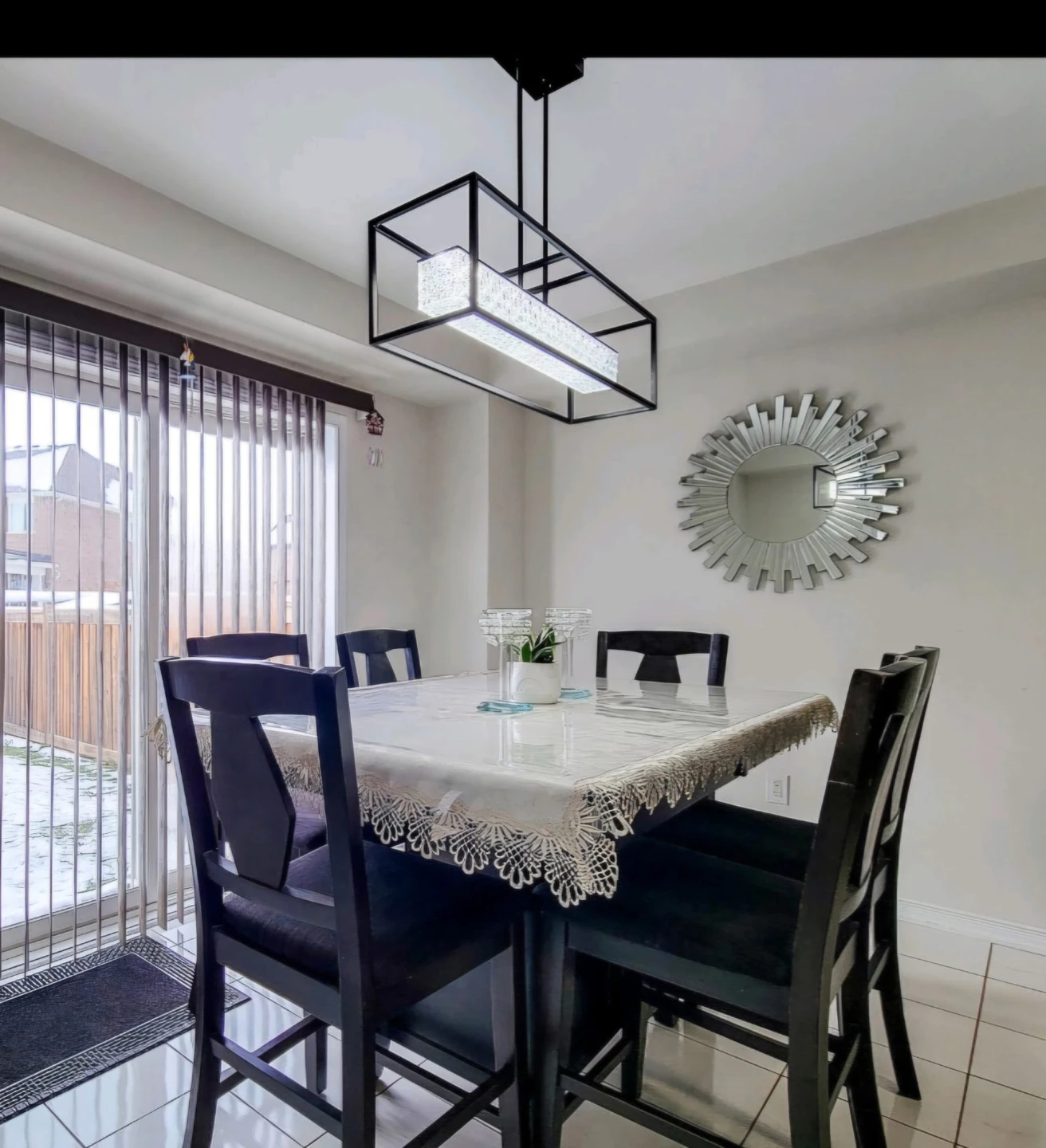 Dining Room Set with Black Chairs and Rectangular Light Fixture