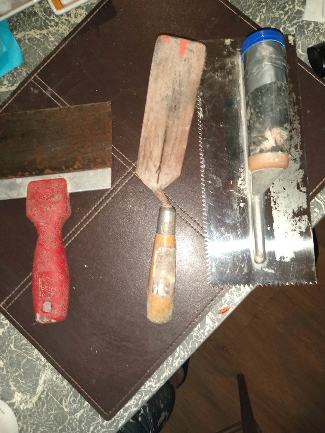 Three gently used plastering tools
