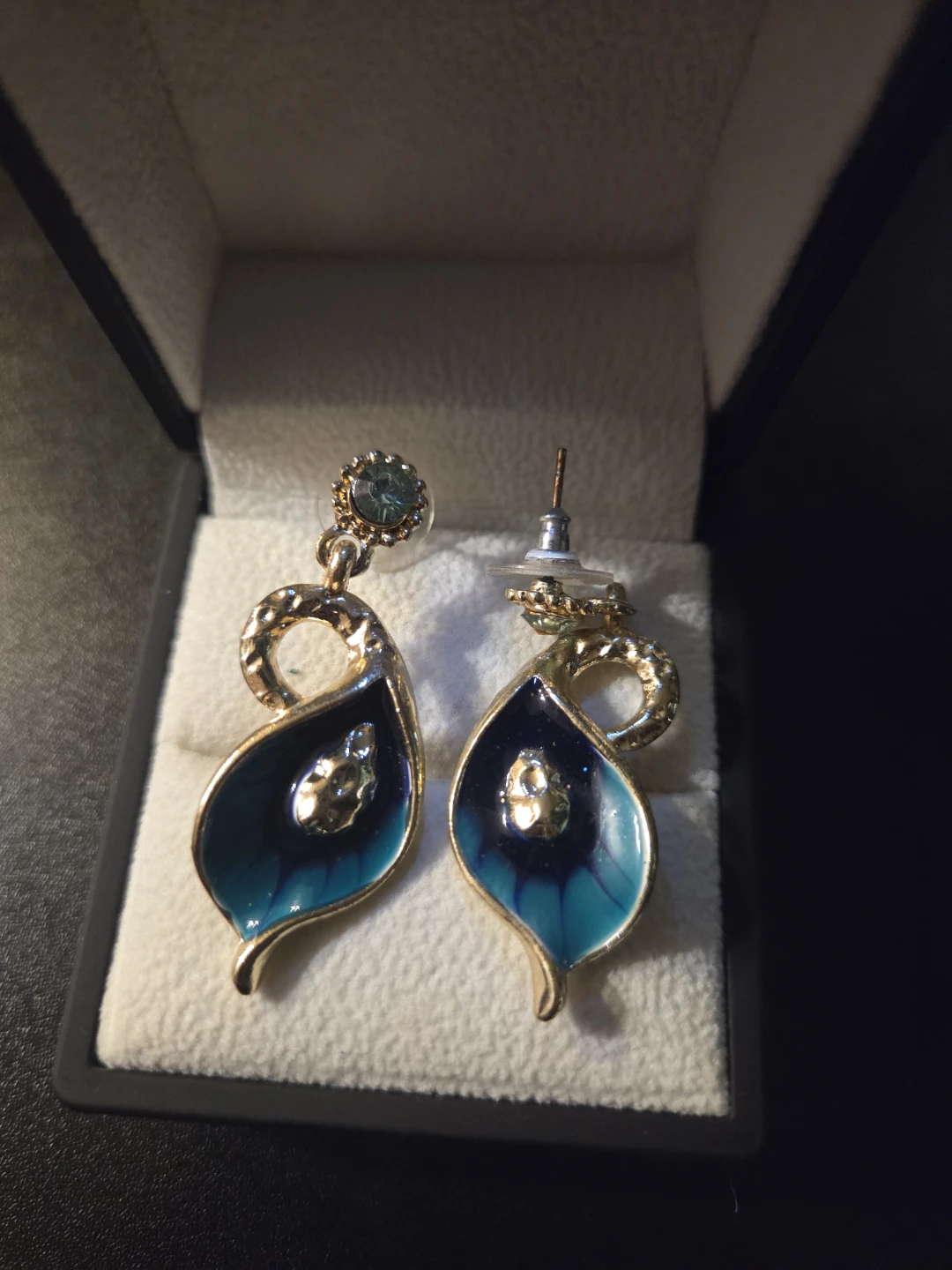 Gold tone dangle earrings with blue and green enamel