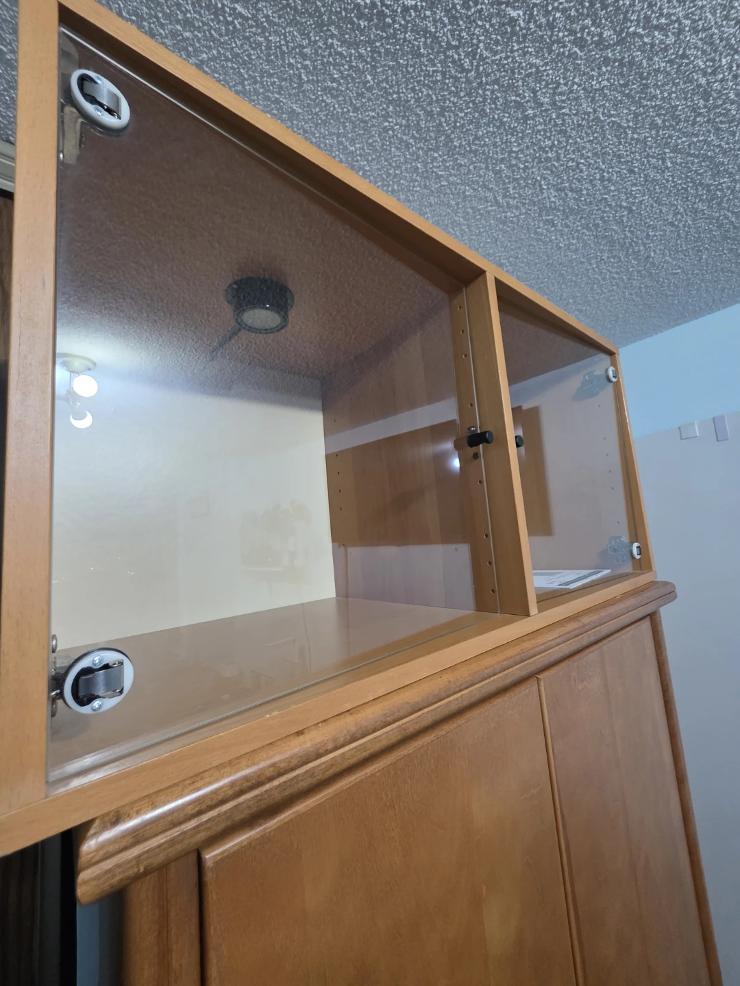 Wooden display cabinet with glass doors