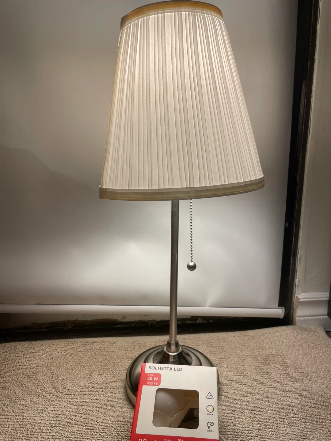 Bedside light with extra light bulb