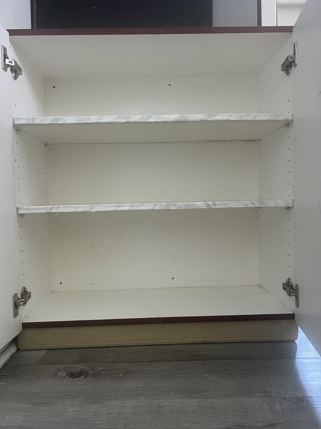 Two-door cabinet with marble-look finish