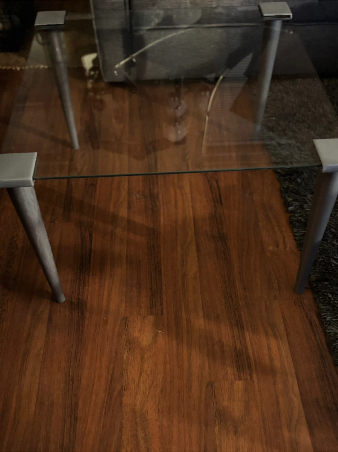 Glass top coffee table with grey legs