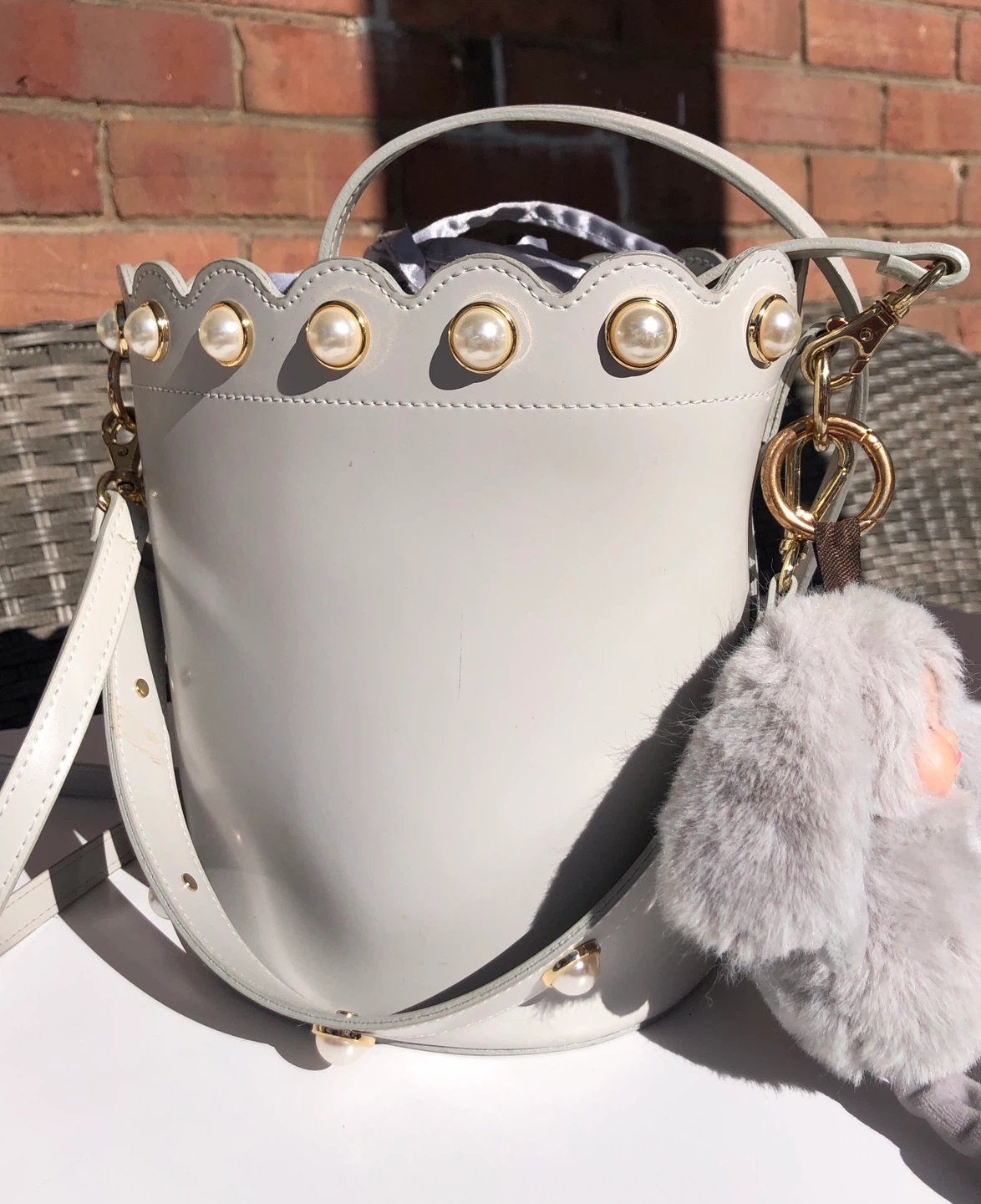 Grey bucket bag with pearl details and fuzzy charm - photo 2