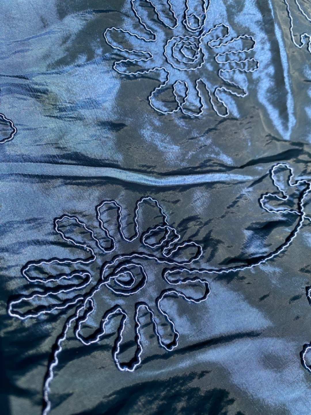 Shiny blue embroidered polyester fabric