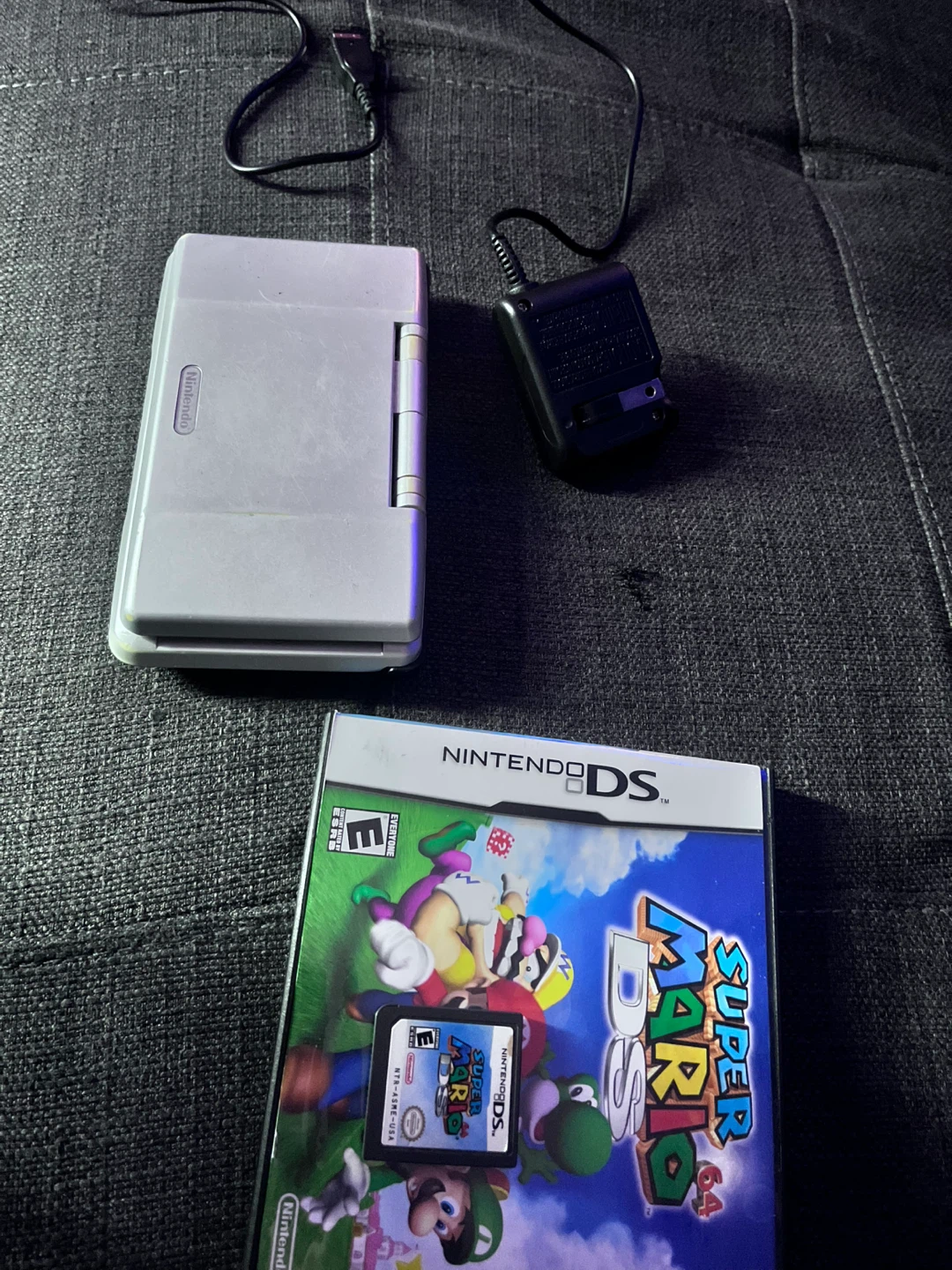 Nintendo DS with Super Mario 64 DS game and charger