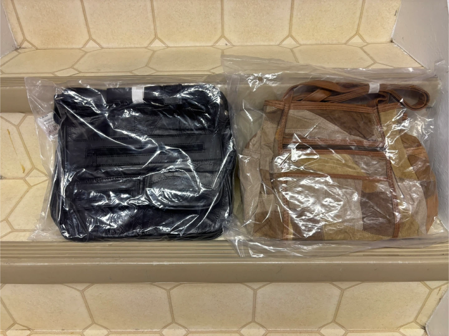 Two women's handbags, black and patchwork leather
