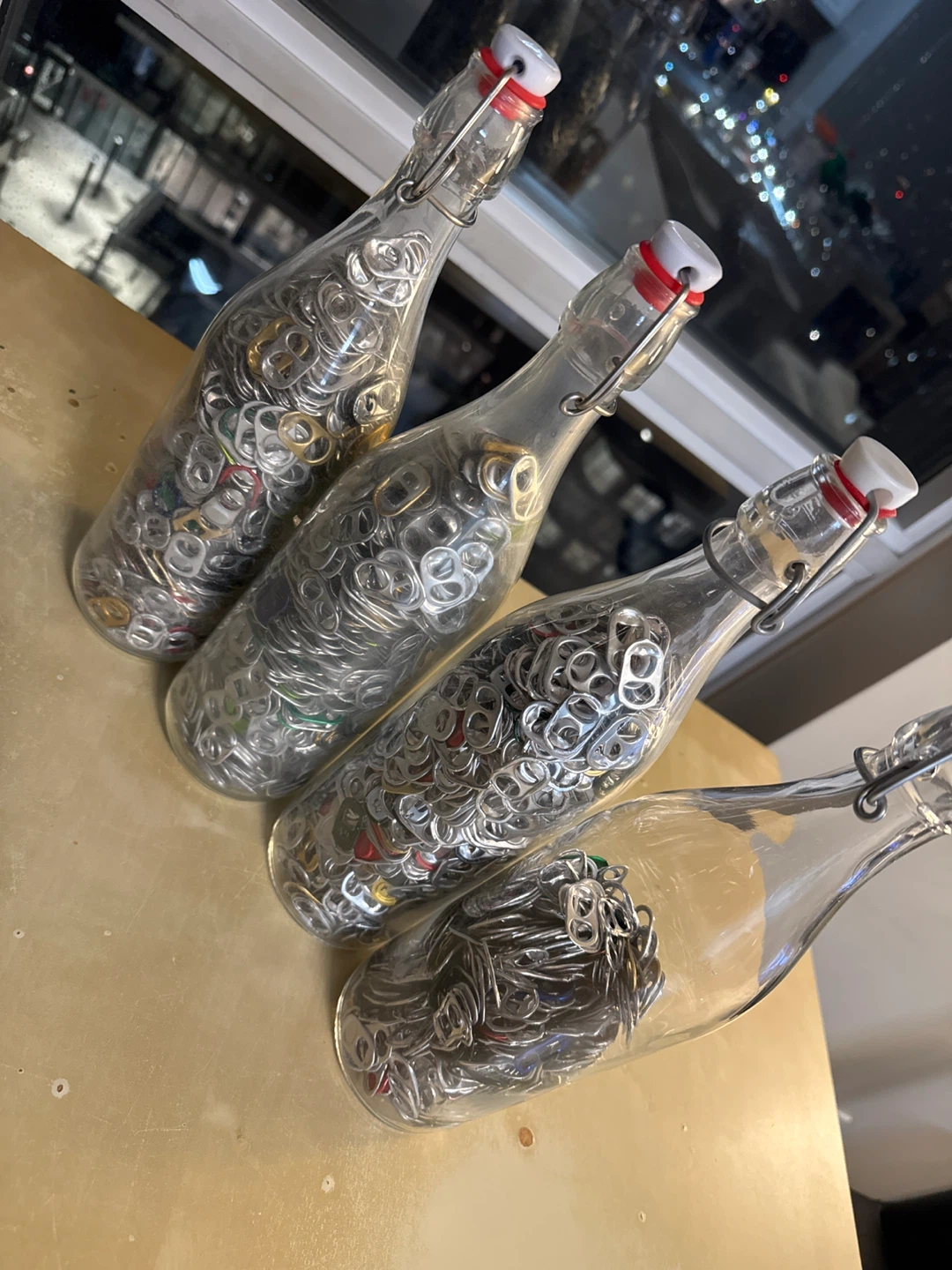 Four bottles full of can tabs