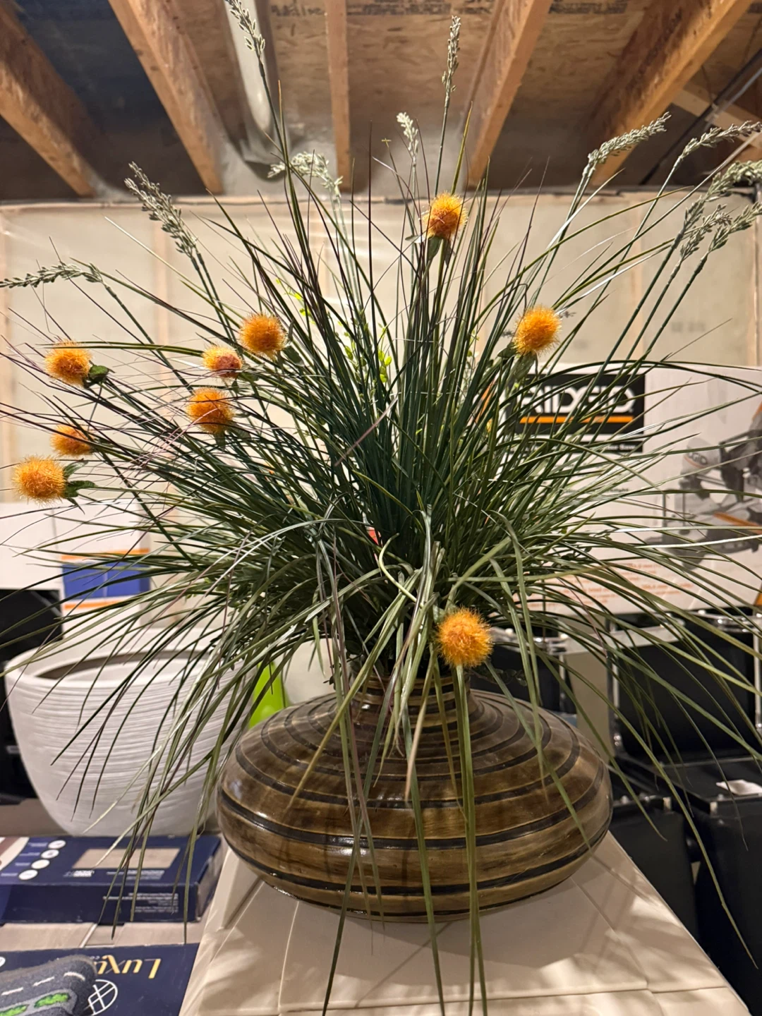 Artificial Grass Arrangement with Orange Flowers