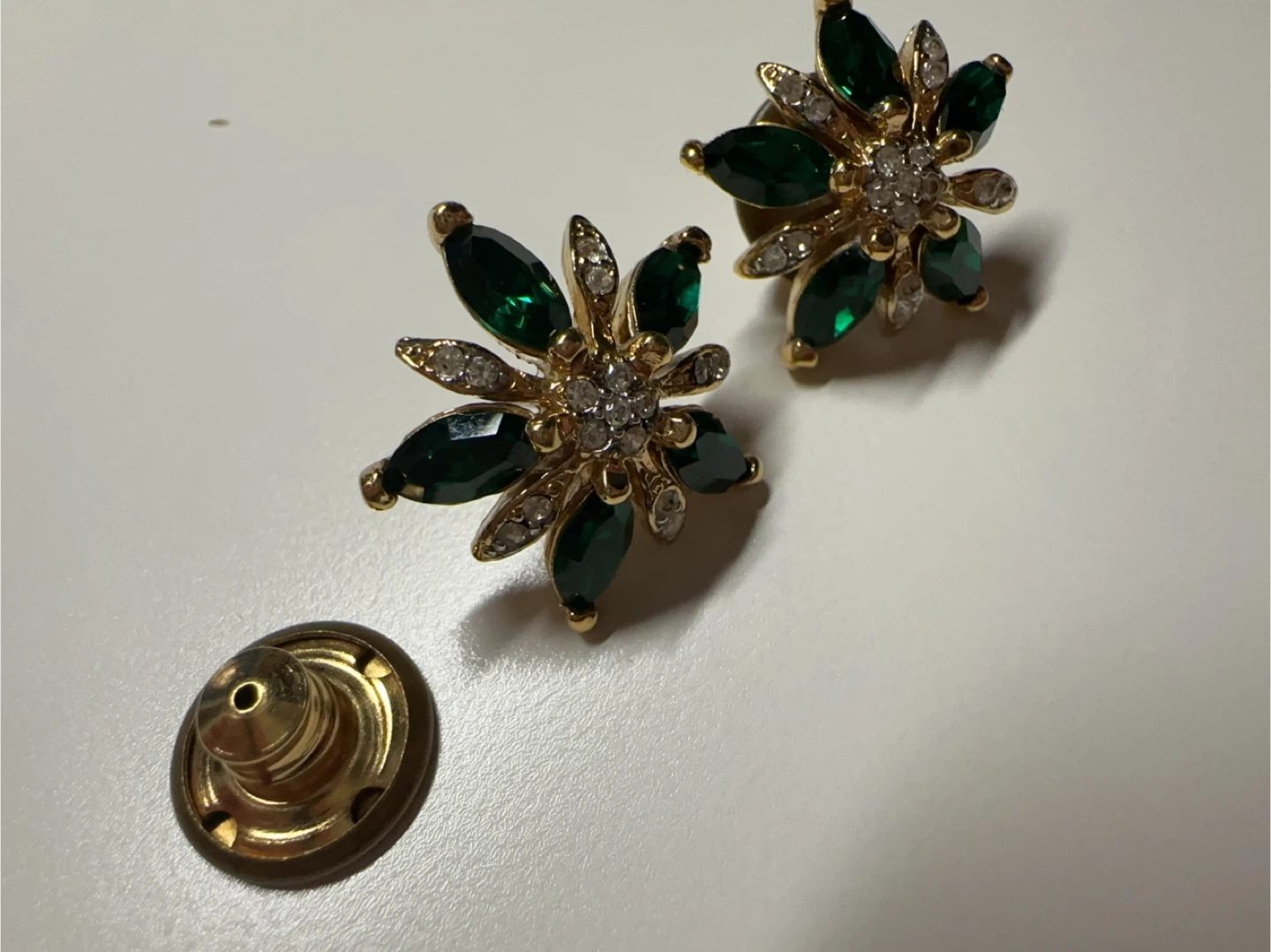 Gold tone flower earrings with green and clear stones