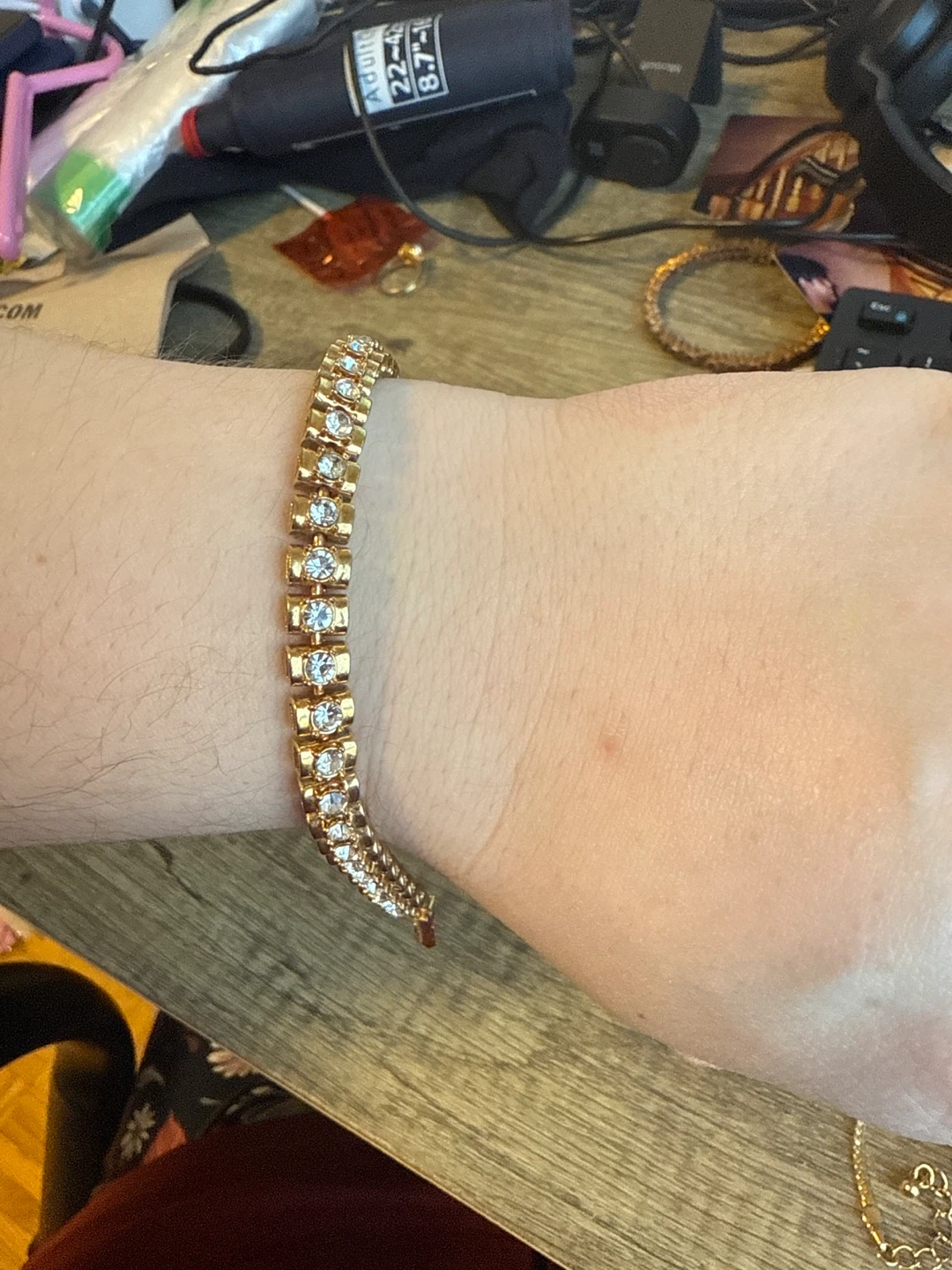 Gold tone tennis bracelet with clear stones