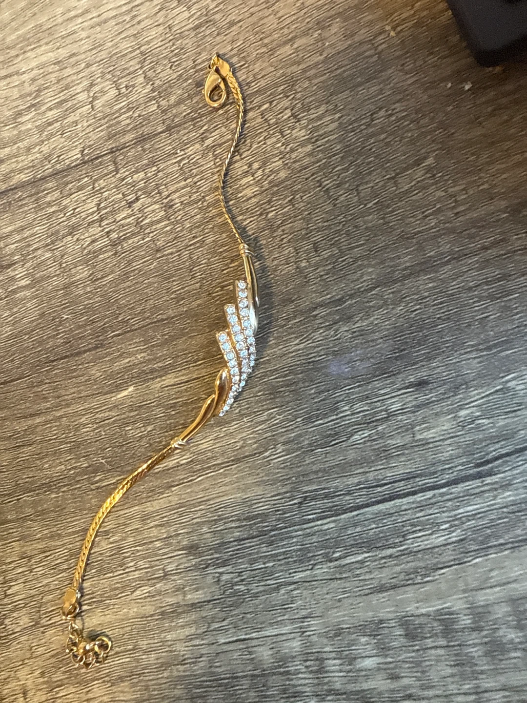 Gold tone bracelet with clear stones