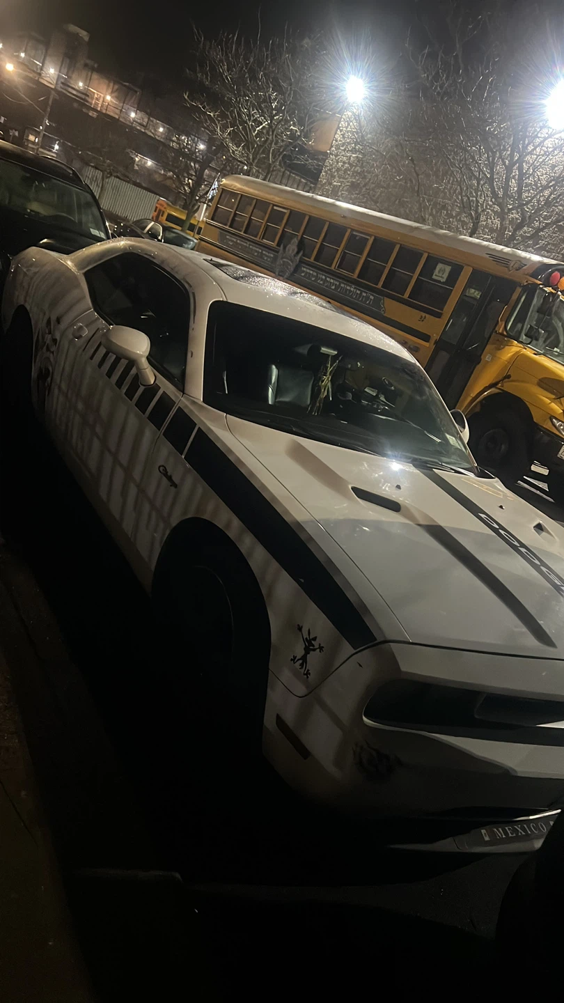 White Dodge Challenger with Black Racing Stripes