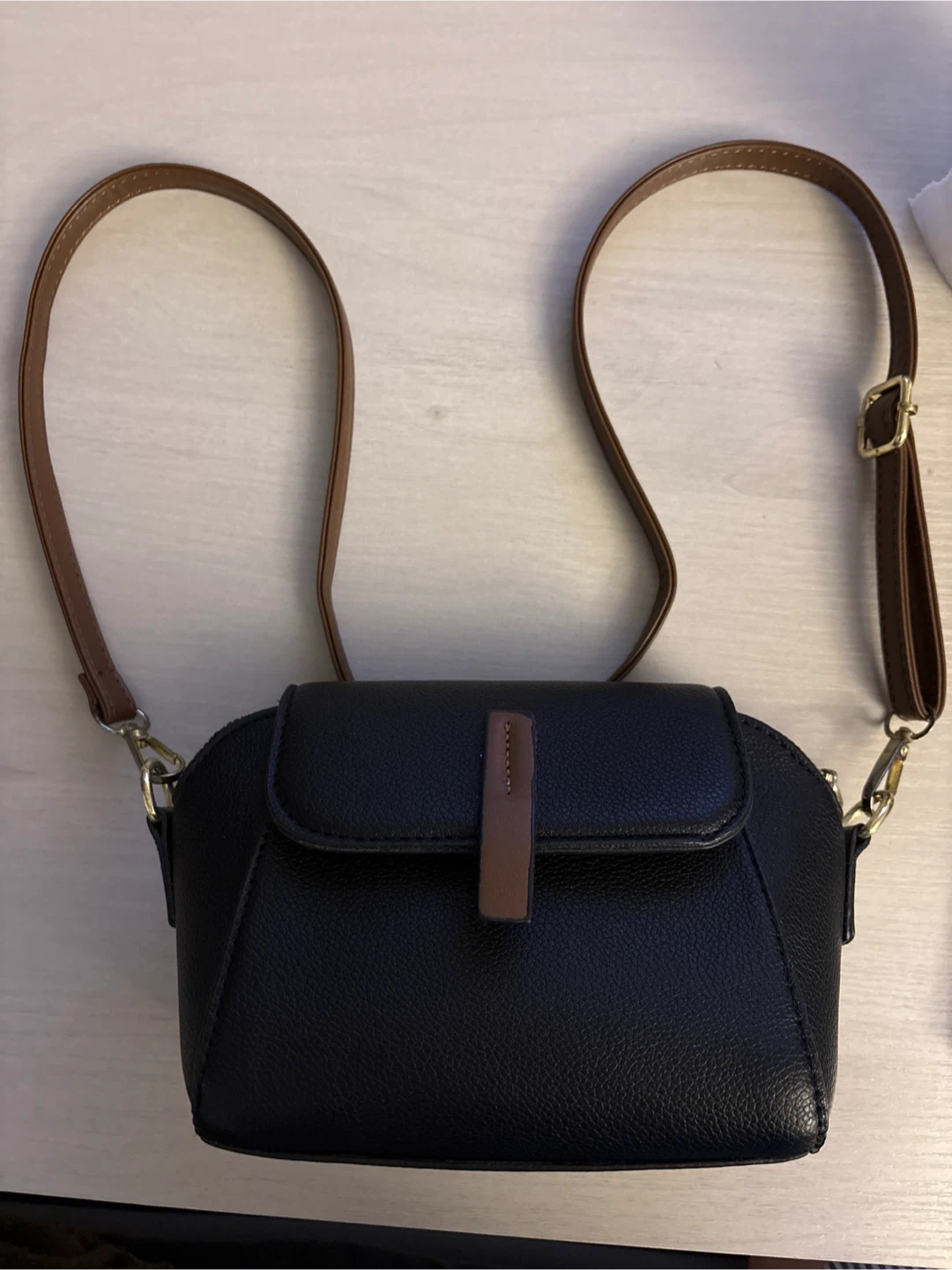 Black crossbody purse with brown strap
